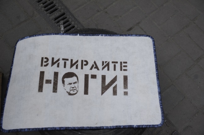 Mezi "suvenýry" najdete i rohožku s portrétem Viktora Janukovyče a nápisem Otři si nohy